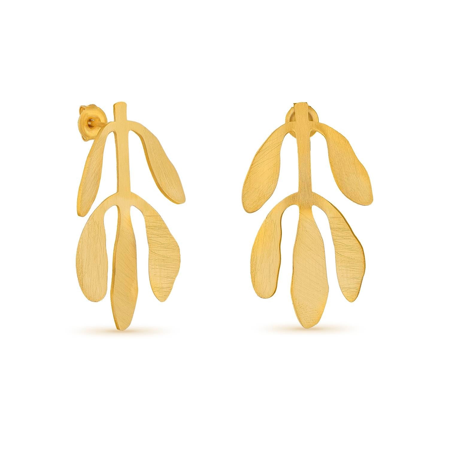 Gold leaf-shaped earrings on a white background