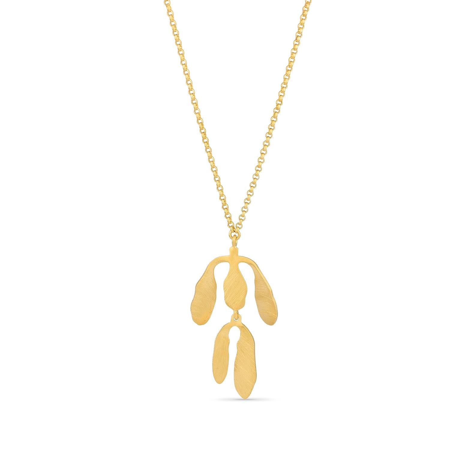 Gold necklace with a leaf-shaped pendant on a white background