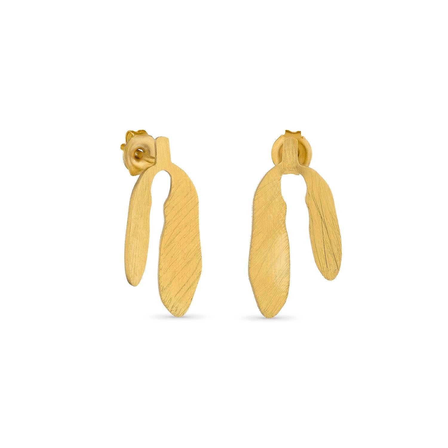 Gold earrings on a white background